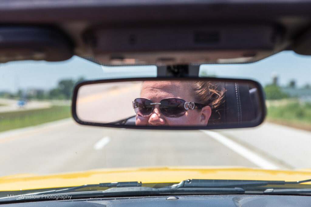 woman in rear view mirror