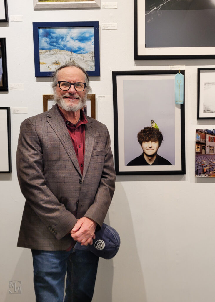 Man in front of photograph